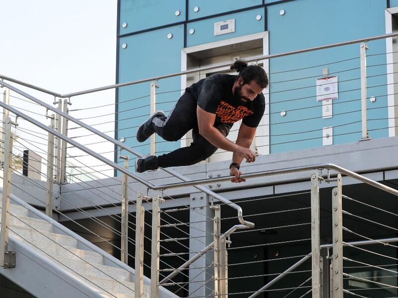Hamzar Mekkaoui, 26, performs parkour, a sport that originated in France in the 1990s, which involves getting around urban obstacles with a fast-paced mix of jumping, vaulting, running and rolling, in the Qatari capital Doha, on August 11, 2020. Parkour, also known as free-running, has now found a small but committed following in Qatar despite evening temperatures that hover around 40 degrees Celsius (104 Fahrenheit) in summer and over-zealous security guards unfamiliar with the sport. KARIM JAAFAR / AFP