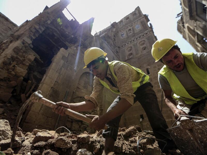 Yemeni labourers remove the rubble ahead of restoration works on the site of a collapsed UNESCO-listed building following heavy rains, in the old city of the Yemeni capital Sanaa, on August 12, 2020. Flash floods triggered by torrential rains have killed at least 172 people across Yemen over the past month, damaging homes and UNESCO-listed world heritage sites, officials said. Mohammed HUWAIS / AFP