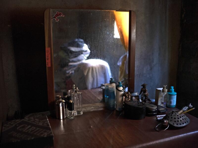 View of belongings at the bedroom of late photojournalist Franklin Rivera, 52, who died from COVID-19, in Ciudad Delgado, El Salvador, on July 13, 2020. Global deaths from the coronavirus have almost reached on September 25, 2020 the grim threshold of one million. Around one-third of fatalities were in Latin America, where countries with overstretched medical resources are preparing for a further onslaught. Yuri CORTEZ / AFP