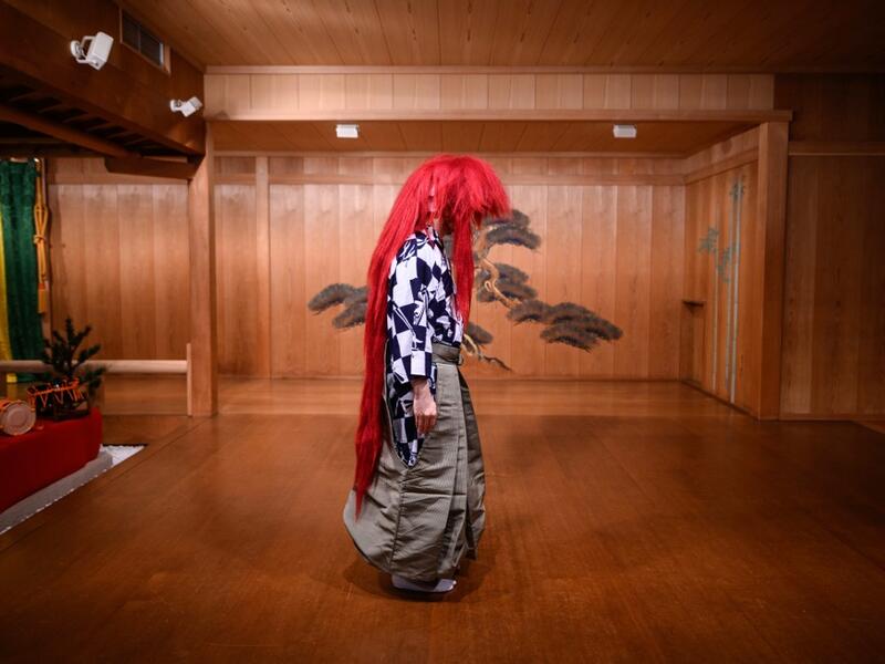 This photo taken on July 29, 2020 shows performer Kennosuke Nakamori posing with a red wig, or "akagashira", after an interview with AFP at the Kamakura Noh Theatre in the town of Kamakura in Kanagawa Prefecture, about one hour southwest of Tokyo. Philip FONG / AFP