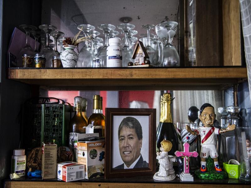 View of a photo of Peruvian Ernesto Diaz, 55, who died from COVID-19 virus on a shelf of his home in Chorrillos, south of Lima, Peru on August 11, 2020. Global deaths from the coronavirus have almost reached on September 25, 2020 the grim threshold of one million. Around one-third of fatalities were in Latin America, where countries with overstretched medical resources are preparing for a further onslaught. ERNESTO BENAVIDES / AFP