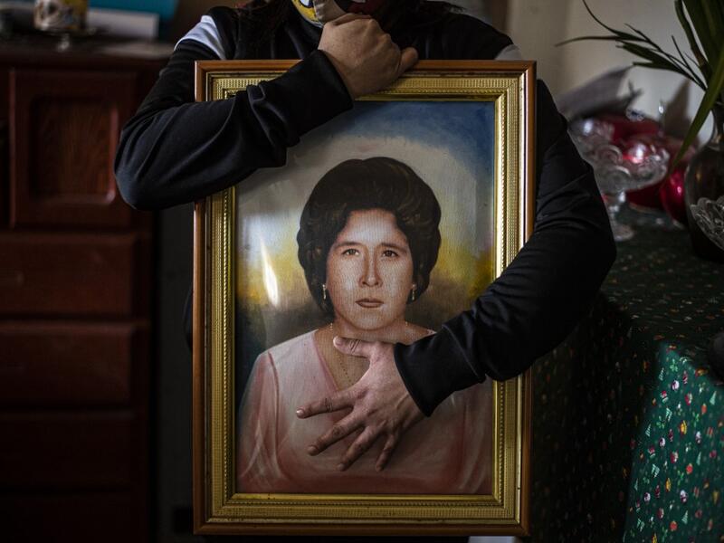 Peruvian Liset Diaz, 35, holds a painting of her grandmother Edita Leiva -in her youth-, 76, who died from COVID-19 at her home in Chorrillos, south of Lima, Peru on August 11, 2020. Global deaths from the coronavirus have almost reached on September 25, 2020 the grim threshold of one million. Around one-third of fatalities were in Latin America, where countries with overstretched medical resources are preparing for a further onslaught. ERNESTO BENAVIDES / AFP