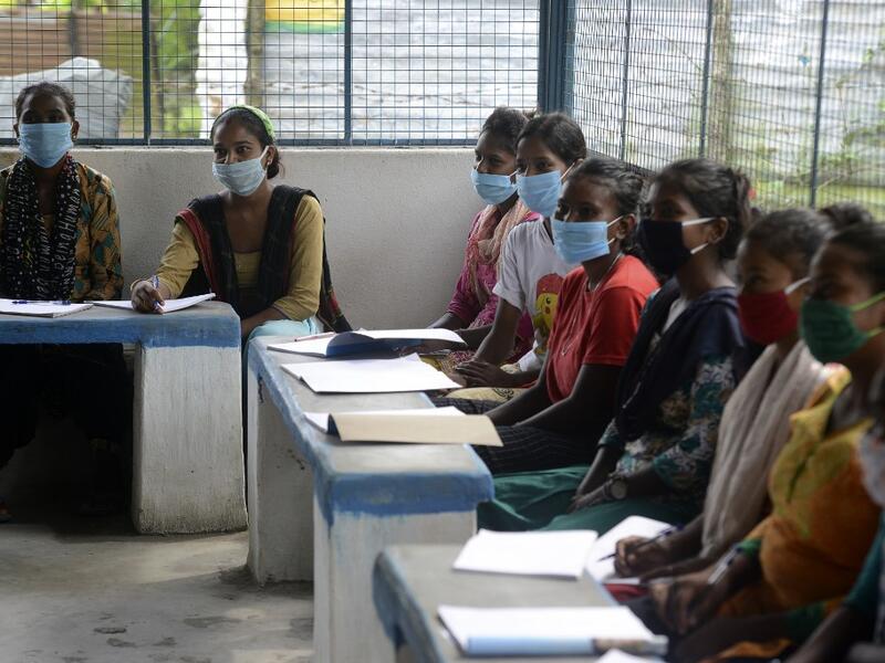 Youths from Merry view Tea Garden organisation attend a class as part of 'Tuition for Rs 10' project, origanized by Indian couple Anirban Nandy and Poulami Chaki Nandy for underprivileged students unable to assist online classes at Hatighisa village, some 26 km from Siliguri, on September 1, 2020, as schools remain closed due the Covid-19 coronavirus pandemic. DIPTENDU DUTTA / AFP