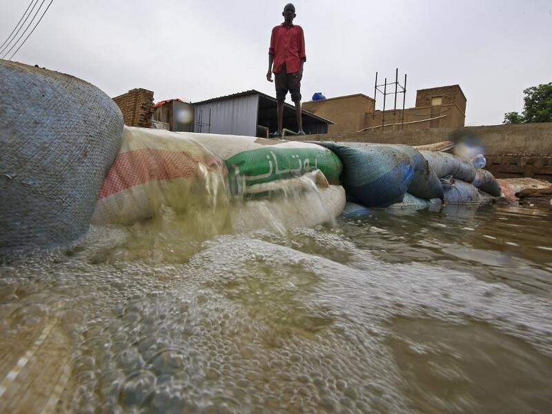 A Sudanese man stands behind a barricade amidst flood waters in Tuti island, where the Blue and White Nile merge between the twin cities of the capital Khartoum and Omdurman, on September 3, 2020. ASHRAF SHAZLY / AFP