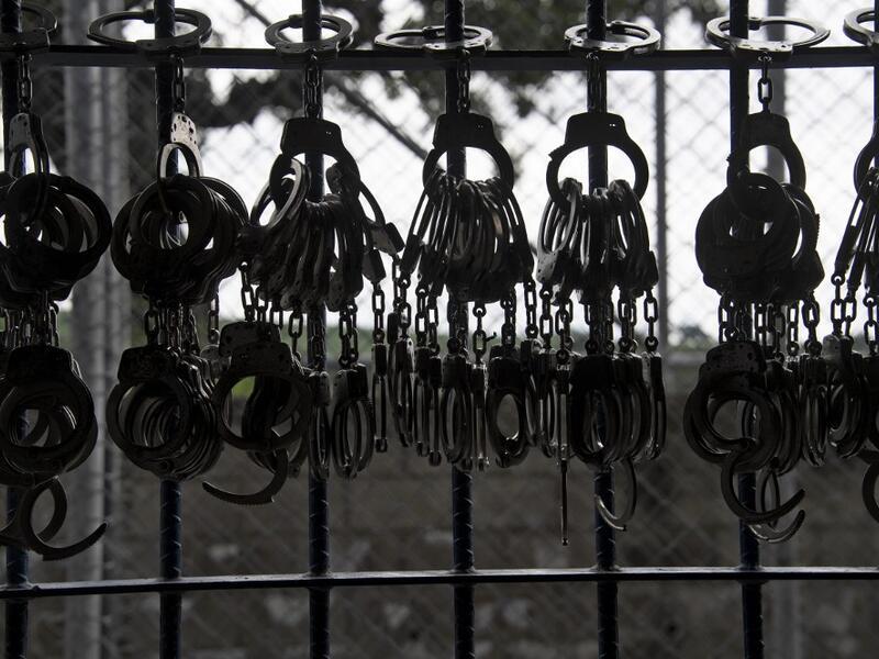 Handcuffs hang from a railing during a search operation at the maximum security prison in Izalco, Sonsonate, El Salvador, on September 4, 2020. Authorities from the General Directorate of Penal Centres (DGCP) visited three Salvadorean prisons, some of maximum security, to check the situation of inmates and carry out searches amid the COVID-19 novel coronavirus pandemic. Yuri CORTEZ / AFP