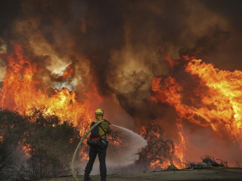 San Miguel County Firefighters battle a brush fire along Japatul Road during the Valley Fire in Jamul, California on September 6, 2020 The Valley Fire in the Japatul Valley burned 4,000 acres overnight with no containment and 10 structures destroyed, Cal Fire San Diego said.  SANDY HUFFAKER / AFP