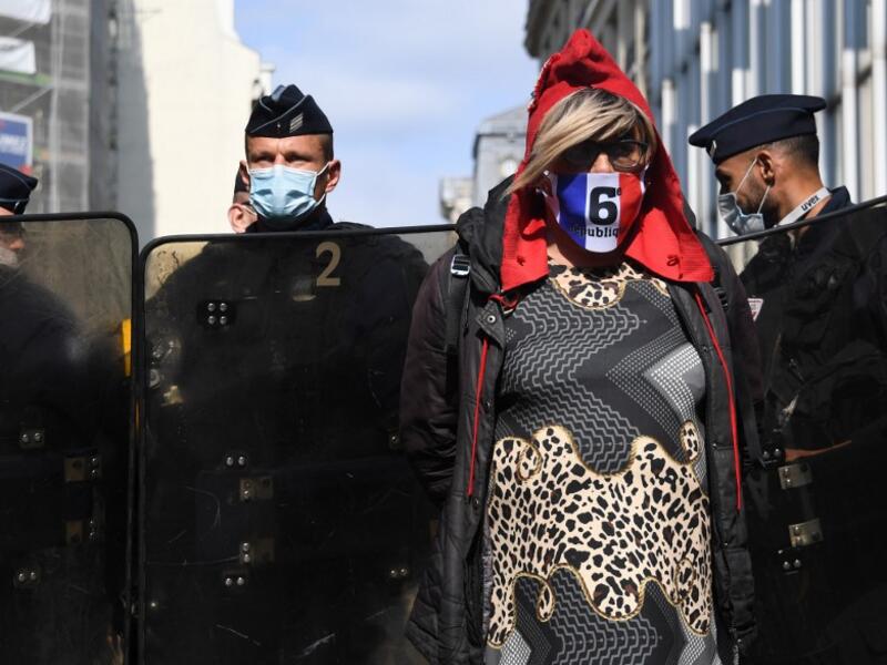 A protester wearing a protective face mask stands in front of riot police officers during a demonstration called by the "yellow vest" (gilets jaunes) movement on September 12, 2020 in Paris. Alain JOCARD / AFP