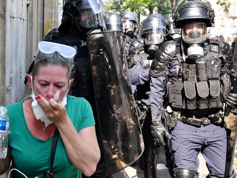 A protester clean her eyes after police fired flee tear gas during a demonstration called by the "yellow vest" (gilets jaunes) movement on September 12, 2020 in Paris. Alain JOCARD / AFP