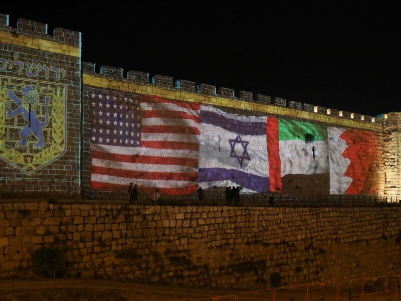The flags of US, Israel, United Arab Emirates, and Bahrain are projected on the ramparts of Jerusalem's Old City on September 15, 2020 in a show of support for Israeli normalisation deals with the United Arab Emirates and Bahrain. The decision by the UAE and Bahrain to normalise ties with Israel breaks with decades of consensus within the Arab world that a peace deal with the Palestinians is a prerequisite for establishing relations with the Jewish state. Menahem Kahana / AFP