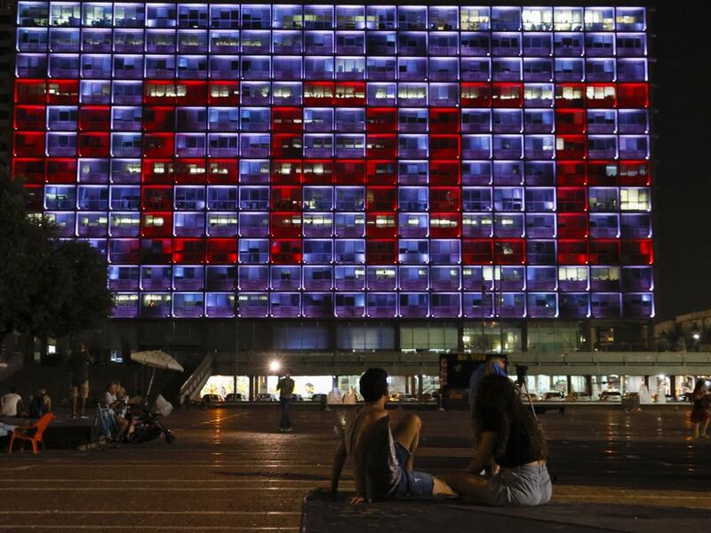 The windows of the Tel Aviv-Yafo Municipality building illuminated with the word "Peace" in English on September 15, 2020 to celebrate the signing of the landmark Israeli normalisation deals with the United Arab Emirates and Bahrain. Israeli Prime Minister Benjamin Netanyahu signed landmark accords normalizing the Jewish state's relations with the United Arab Emirates and Bahrain, as part of a peace push brokered by US President Donald Trump.  JACK GUEZ / AFP