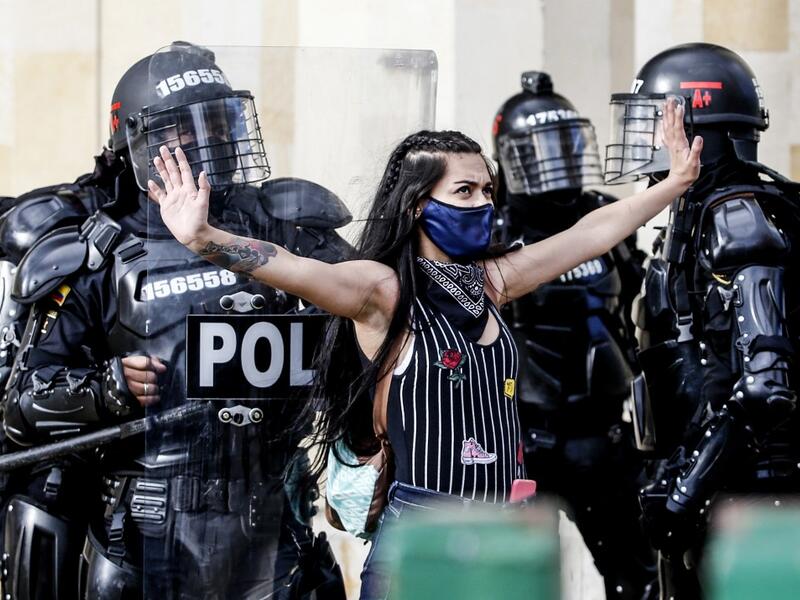 Riot police detain a demonstrator during protests against police brutality in Bogota on September 21, 2020. Large groups of protesters are mobilizing in Colombia against police violence and in rejection of the government, after the bloody protests that unleashed the recent murder of a man at the hands of two uniformed men. LEONARDO MUNOZ / AFP