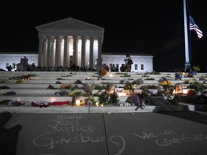 The national flag flies at half staff as people gather to mourn the passing of Supreme Court Justice Ruth Bader Ginsburg at the steps in front of the Supreme Court on September 18, 2020 in Washington, DC. Ginsburg has died at age 87 after a battle with pancreatic cancer. Tasos Katopodis/Getty Images/AFP TASOS KATOPODIS / GETTY IMAGES NORTH AMERICA / Getty Images via AFP