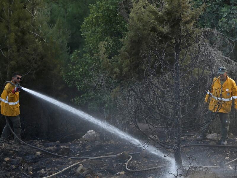 Several fires spread across northern and central Israel and the occupied West Bank as temperatures soared, forcing the evacuation of thousands of people, authorities said  JALAA MAREY / AFP