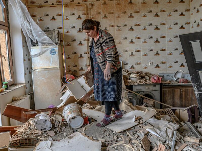 Xatire Celilova walks in the kitchen of her destroyed flat following a ceasefire during a military conflict between Armenia and Azerbaijan over the breakaway region of Nagorno-Karabakh, in the town of Terter, Azerbaijan, on October 10, 2020. Armenia and Azerbaijan traded accusations of new attacks on October 10 in breach of a ceasefire deal to end nearly two weeks of heavy fighting over the disputed Nagorno-Karabakh region. Bulent Kilic / AFP