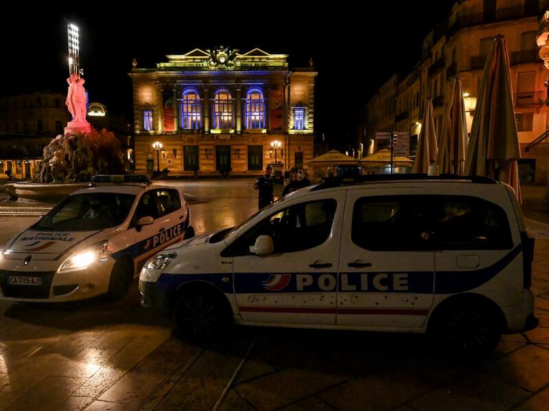 French Police officers stand next to their cars in Montpellier on October 17, 2020, as a curfew is in place to fight the spread of Covid-19. About 20 million people in the Paris region and eight other French cities were facing a 9 pm-6 am curfew from October 17, after cases surged in what has once again become one of Europe's major hotpots. Pascal GUYOT / AFP