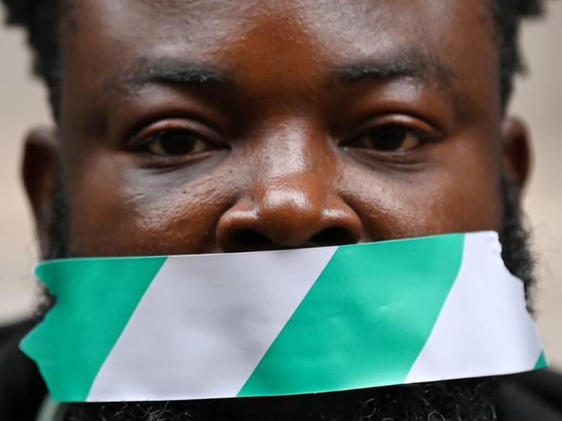 Protestors attend a demonstration outside the Nigerian High Commission against police brutality in Lagos in London on October 21, 2020. UN Secretary General Antonio Guterres called Wednesday for an end to what he called "brutality" by police in Nigeria, which has been rocked by two weeks of protests. Guterres said gunmen that opened fire on peaceful protesters Tuesday evening in Lagos caused "multiple deaths" and many injuries. DANIEL LEAL-OLIVAS / AFP