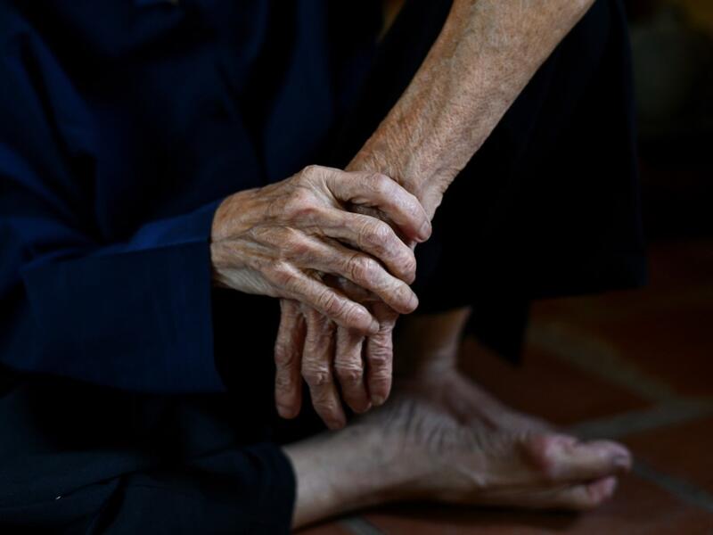 This photograph taken on October 8, 2020 shows 89-year-old Vietnamese artist Mong Bich pausing while painting inside her house in Bac Ninh province, east of Hanoi. Bich specialises in silk paintings of daily life and ordinary people, women in particular, and ploughed a lonely furrow during many years of war when artists were steered towards the army or frontline workers as subjects. Manan VATSYAYANA / AFP