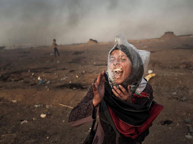 A Palestinian woman screams during a protest against the Israel siege of Gaza Strip at Gaza’s Eastern border, May 2018. Plastic bags are used by demonstrators to protect themselves against teargas.⁣ From ‘The Great March of Return’ by Fabio Bucciarelli (@fabio_bucciarelli) for Yahoo News (@yahoonews).⁣ ⁣ (Instagram)