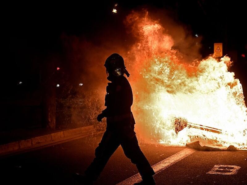 Protests erupted across Italy and Spain last night as thousands of angry demonstrators called on their Governments to reconsider a second-round of lockdown restrictions. Vast crowds gathered on the streets of Barcelona with angry protesters setting dustbins on fire  (AFP)