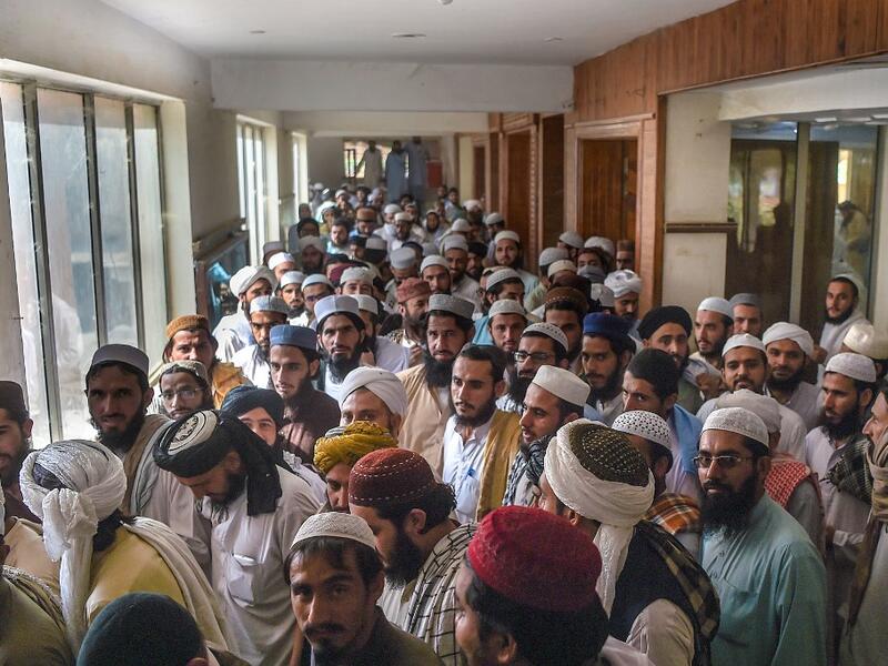 In this picture taken on October 19, 2020 Islamic seminary students leave a classroom at the Darul Uloom Haqqania seminary in Akora Khattak. The Darul Uloom Haqqania seminary has churned out a who's who of Taliban top brass -- including many now on the hardline group's negotiating team holding talks with the Kabul government to end a 20-year war. Abdul MAJEED / AFP