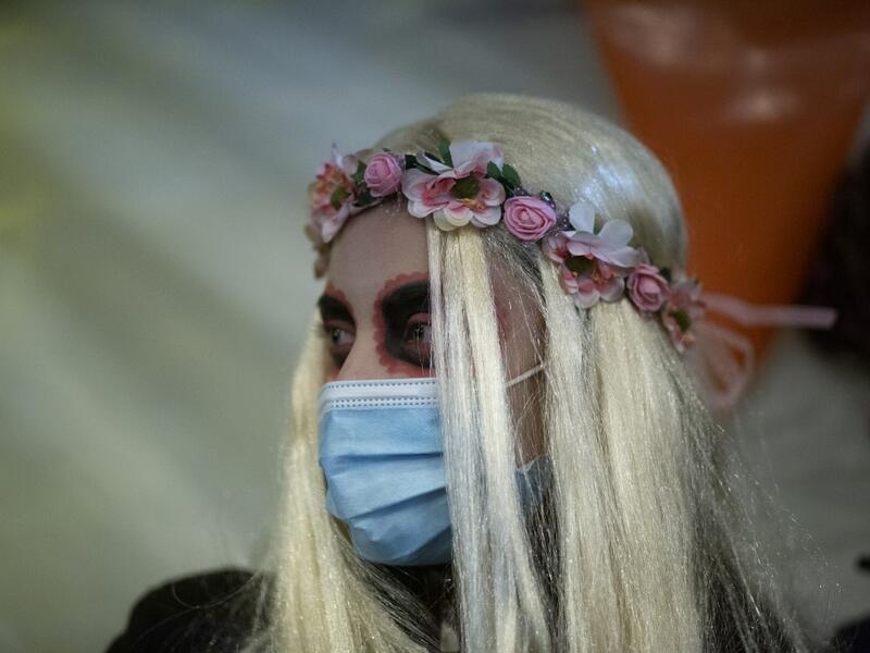 A woman in Halloween costume is seen in Greenwich Village on Halloween night in Manhattan on October 31, 2020, in New York City. Kena Betancur / AFP