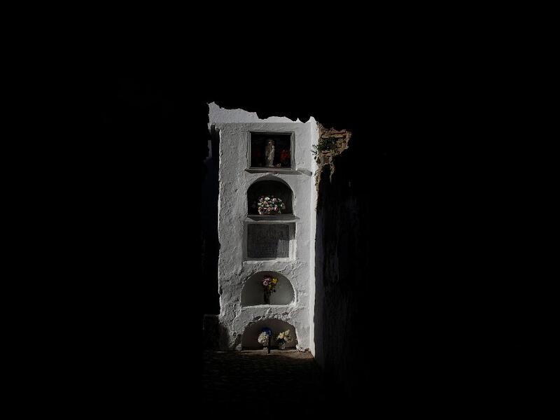 Flowers are laid at the Cemetery of Villaluenga del Rosario near Cadiz on All Saints' Day on November 1, 2020. The Cemetery of Villaluenga is built on the ruins of the El Salvador Church which was burnt during the war of independence. CRISTINA QUICLER / AFP