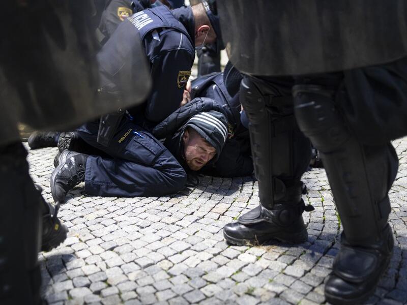 Police officers hold down a protestor as they clash with police during the rally against government’s coronavirus restrictions in Ljubljana on November 5, 2020. Jure Makovec / AFP
