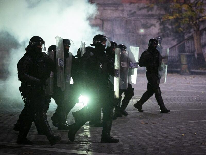 Police officers wearing anti-riot gear charge against protesters during the rally against government’s coronavirus restrictions in Ljubljana on November 5, 2020. Jure Makovec / AFP