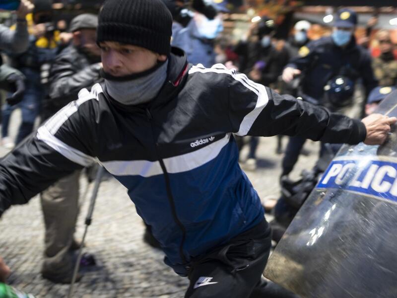 A protestor clashes with police officers during the rally against government’s coronavirus restrictions in Ljubljana on November 5, 2020. Jure Makovec / AFP
