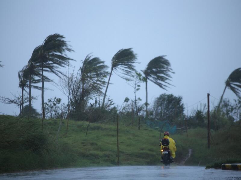 A motorist passes along a street amidst strong winds in Legazpi City, Albay province on November 11, 2020, ahead of the landfall of Tropical Storm Vamco -- expected to intensify into a typhoon -- in the region devastated by two typhoons in less than three weeks. Charism SAYAT / AFP