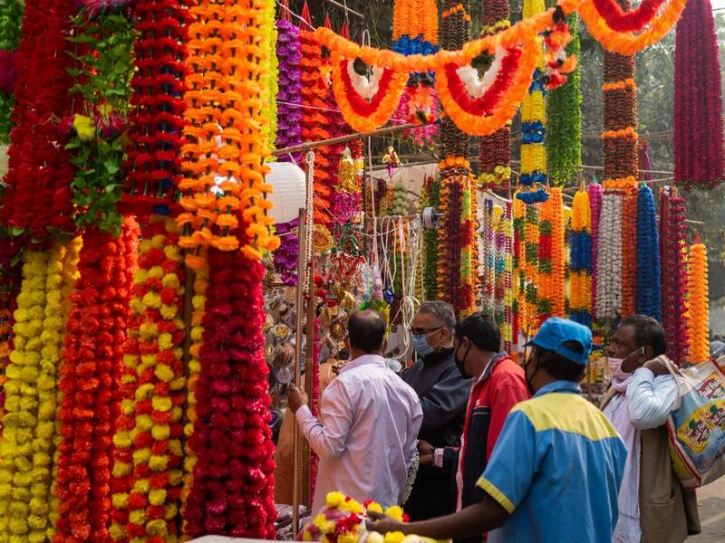 People buy decorations for Diwali, the Hindu Festival of Lights, from a stall in a market area in New Delhi on November 14, 2020. Jewel SAMAD / AFP