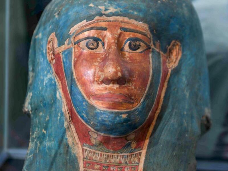 A picture shows a funerary mask on display during the unveiling of an ancient treasure trove of more than a 100 intact sarcophagi, at the Saqqara necropolis 30 kms south of the Egyptian capital Cairo, on November 14, 2020. Egypt announced the discovery of an ancient treasure trove of more than a 100 intact sarcophagi, the largest such find this year. The sealed wooden coffins, unveiled on site amid fanfare, belonged to top officials of the Late Period and the Ptolemaic period of ancient Egypt. They were fou