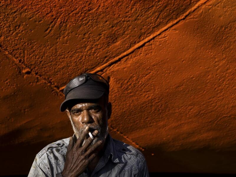 In this picture taken on November 11, 2020 dockyard worker smokes a cigarette next the hull of a ship on the banks of the Buriganga river in Char Kaliganj on the outskirts of Dhaka. Rivers are the lifeblood of the delta nation of 168 million people where much of the low-lying land is accessed via boat, with Bangladesh's strong economic growth of recent years fuelling more investments in new and bigger ships. Munir UZ ZAMAN / AFP