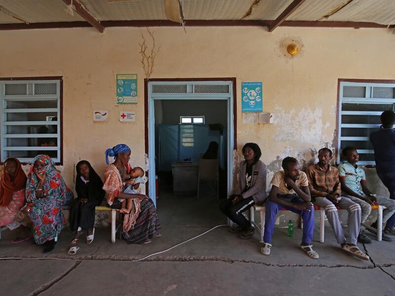 Ethiopian refugees who fled the fighting in the Tigray wait outside an aid facility in the Hamdayet area of Sudan's eastern Kassala state, on November 22, 2020. Ethiopia's northern Tigray region has been rocked by bloody fighting since November 4, when Ethiopia announced the launch of military operations there. The ongoing conflict is reported to have killed hundreds of people and forced thousands more to flee into neighbouring Sudan. ASHRAF SHAZLY / AFP