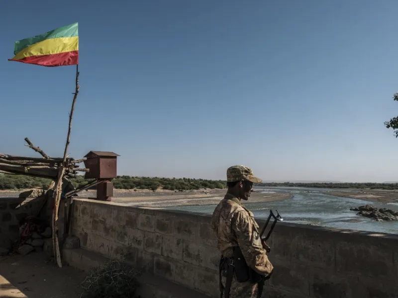 A member of the Amhara Special Forces watches on at the border crossing with Eritrea where an Imperial Ethiopian flag waves, in Humera, Ethiopia, on November 22, 2020. EDUARDO SOTERAS / AFP