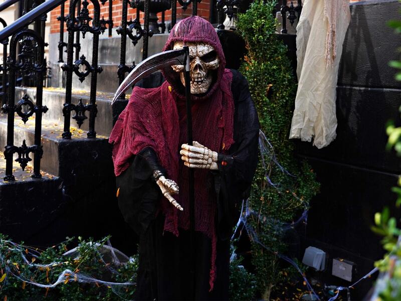 An Upper East Side home is decorated with a Grim Reaper skeleton for Halloween on October 31, 2020 in New York City. Many Halloween events have been canceled or adjusted with additional safety measures due to the ongoing coronavirus (COVID-19) pandemic. Cindy Ord/Getty Images/AFP