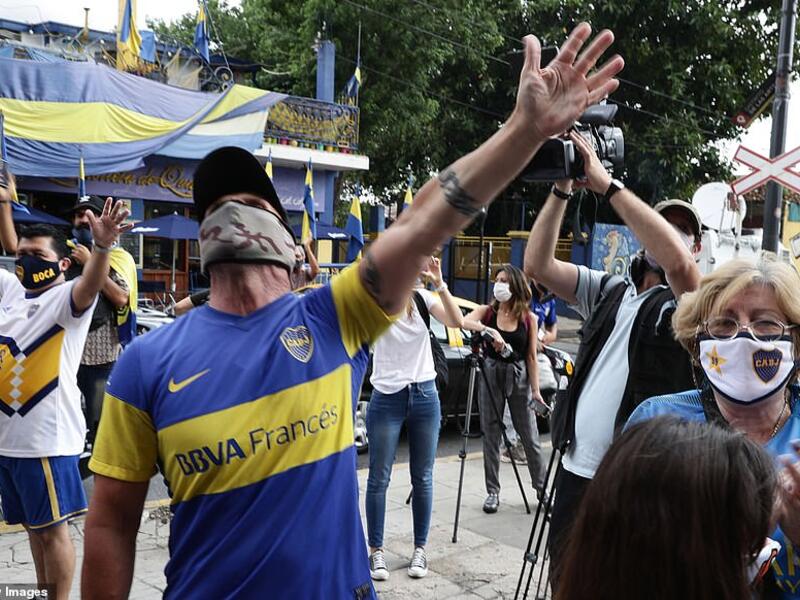 Argentine football star Diego Maradona fans sing slogans outside the entrance of Argentina's Boca Juniors La Bombonera stadium where people gather to mourn his death in Buenos Aires, on November 25, 2020. (AFP/File)