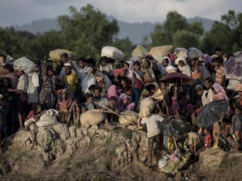 This file photo taken on October 10, 2017 shows Rohingya refugees fleeing from Myanmar arrive at the Naf river in Whaikyang, Bangladesh border.//AFP