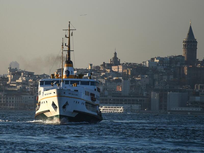 A ferry boat sails on the Bosphorus Strait to the Asia side in Istanbul with the Galata tower seen in the background on November 27, 2020. Ozan KOSE / AFP