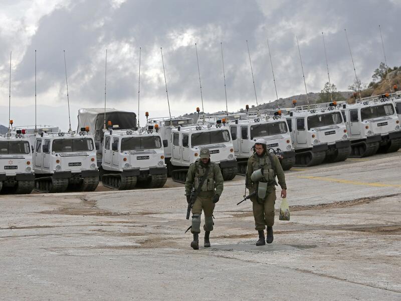 Israeli soldiers walk in the Mount Hermon military base, a strategic and fortified outpost at the crossroads between Israel, Lebanon and Syria, in the Israeli-annexed Golan Heights, on November 30, 2020. JALAA MAREY / AFP