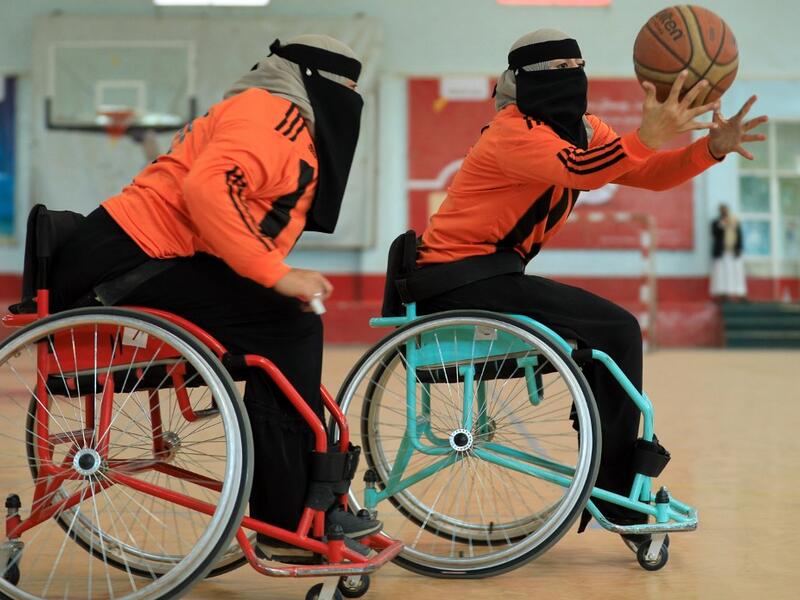 Disabled Yemeni women take part in a local wheelchair basketball championship in Yemen's capital Sanaa on December 8, 2020. In conflict-ridden Yemen, nine teams, including five-all women groups, competed in a local championship for the disabled in the capital Sanaa, which has been under rebel control since 2014. The players are competing to be embraced by society for their strengths rather than be viewed as a burden during the time of war. Mohammed HUWAIS / AFP