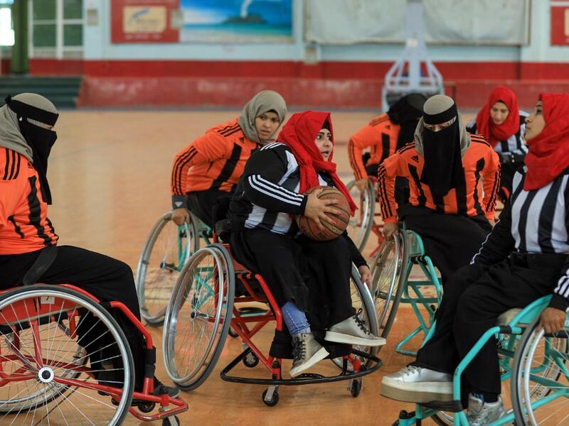 Disabled Yemeni women take part in a local wheelchair basketball championship in Yemen's capital Sanaa on December 8, 2020. In conflict-ridden Yemen, nine teams, including five-all women groups, competed in a local championship for the disabled in the capital Sanaa, which has been under rebel control since 2014. The players are competing to be embraced by society for their strengths rather than be viewed as a burden during the time of war. Mohammed HUWAIS / AFP