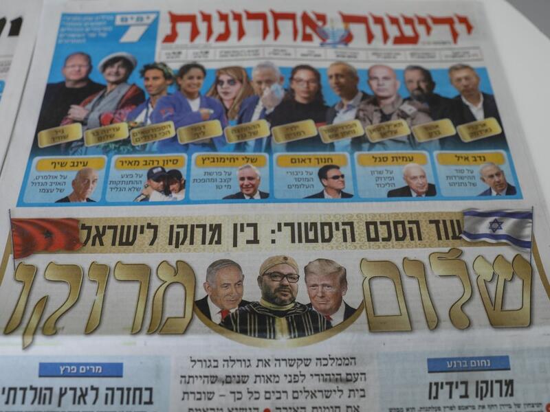 This picture taken on December 11, 2020 in Jerusalem shows Israeli newspapers' front page titles about the announcement that Israel is to establish diplomatic relations with Morocco. Outgoing President Donald Trump's double announcement of a normalisation of ties between Morocco and Israel and US recognition of Moroccan sovereignty over Western Sahara has prompted mixed reactions. In a statement by the royal palace, Morocco's King Mohammed VI confirmed on December 10 that his country would "resume official 