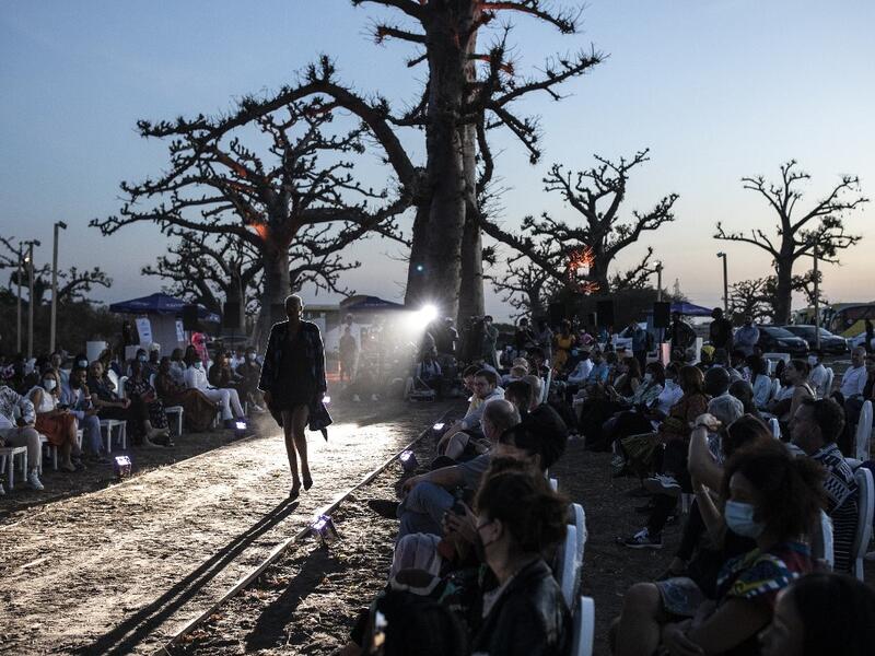 A fashion model walks down the runway during Dakar Fashion Week in Dakar on December 12, 2020. JOHN WESSELS / AFP