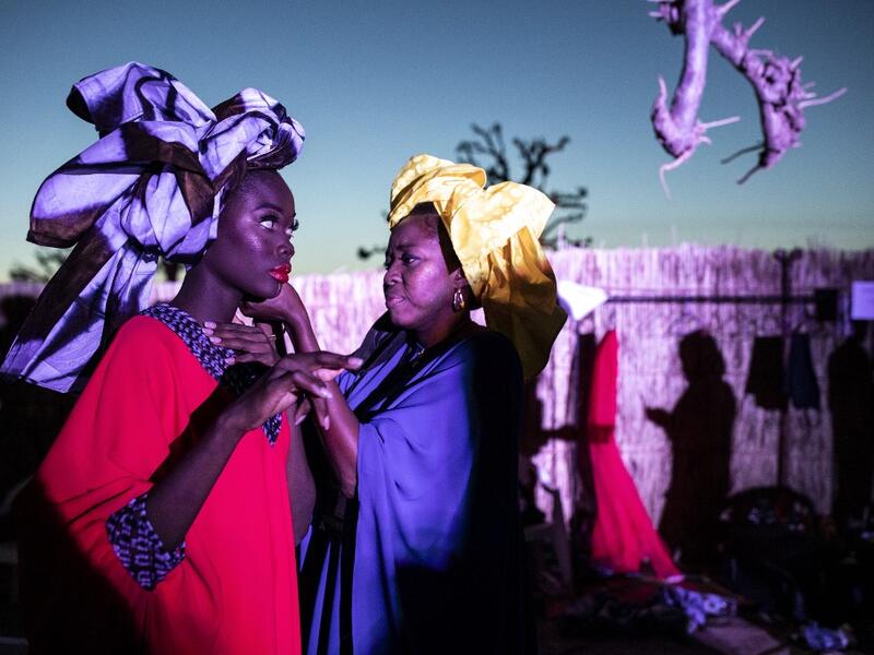 A fashion model gets the final touches done to her outfit during Dakar Fashion Week in Dakar on December 12, 2020. JOHN WESSELS / AFP