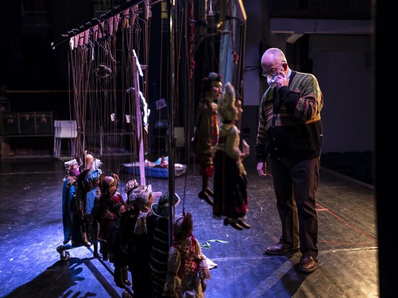 Augusto Grilli checks his puppets on the stage at the " Alfa Theatre" in Turin, on November 30, 2020. The Grilli family has a collection of more than 20,000 objects from around the world, everything from theatres, marionettes and glove puppets to shadow figures and silhouettes. A long-time dream of Grilli and his wife Mariarosa, 78, the museum is due to open in 2023 in Turin, financed both privately and publicly with the help of different institutions.  Marco Bertorello / AFP