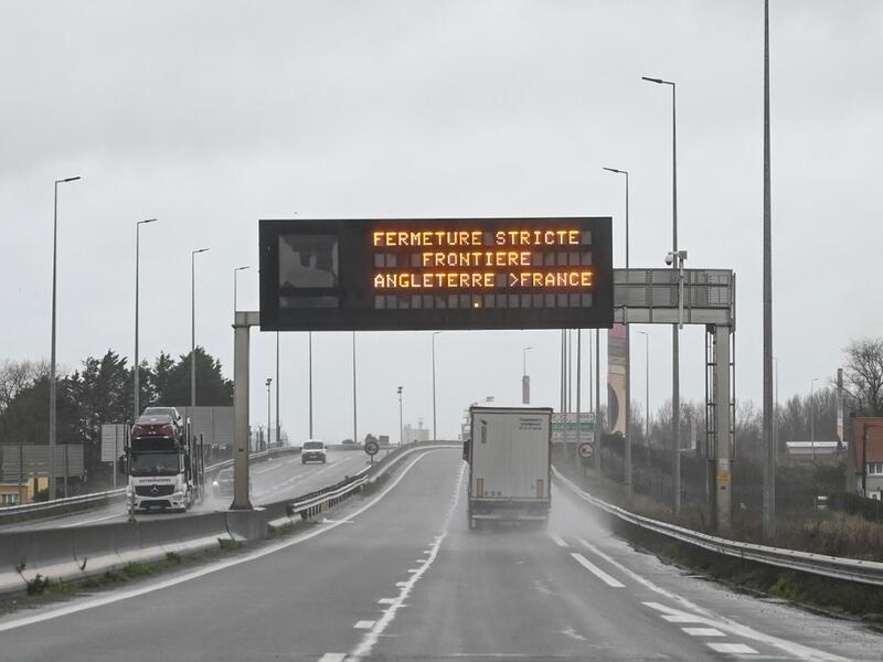 A truck drives by a sign indicating the border closure from England to France on a road in Calais on December 21, 2020 as countries worldwide banned arrivals from the UK on december 20 over a new highly infectious coronavirus strain Britain said was "out of control", as the WHO called for stronger containment measures.  DENIS CHARLET / AFP