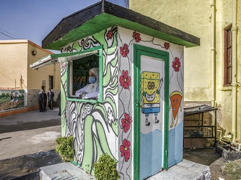 This picture taken during a government-guided tour on December 27, 2020 shows an inmate, mask-clad due to the COVID-19 coronavirus pandemic, manning a commissary stall at al-Qanatir women's prison, at the tip of the Nile delta in Qalyoubiya province, about 30 kilometres north of Egypt's capital. Khaled DESOUKI / AFP