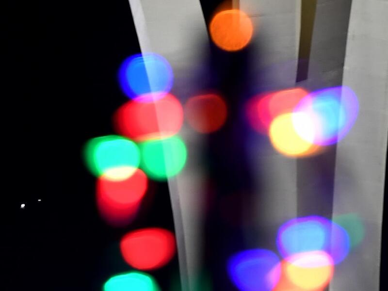 Jupiter (L) and Saturn appear about one-tenth of a degree apart during an astronomical event known as a Great Conjunction behind Christmas lights in the front yard of a house on December 21, 2020 in Las Vegas, Nevada. Ethan Miller / GETTY IMAGES NORTH AMERICA / Getty Images via AFP