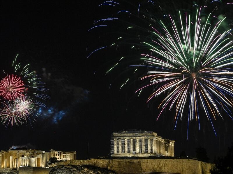Fireworks explode over the ancient Acropolis in Athens during the new year's celebrations on December 31, 2020. LOUISA GOULIAMAKI / AFP